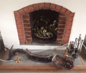 small fireplace before a stove