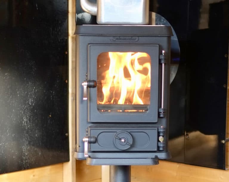 Shed small stove installation with a wall exit flue set up