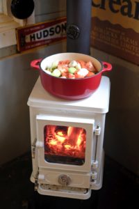 small multi fuel stove used for cooking and heating a small garden room home office