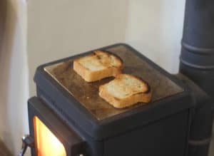 tiny wood stove turning bread into toast