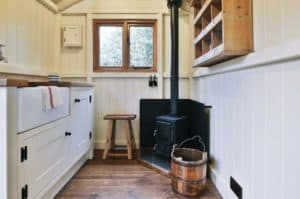 small stove in a shepherd's hut red sky