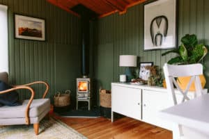 small log burner installed in a shed
