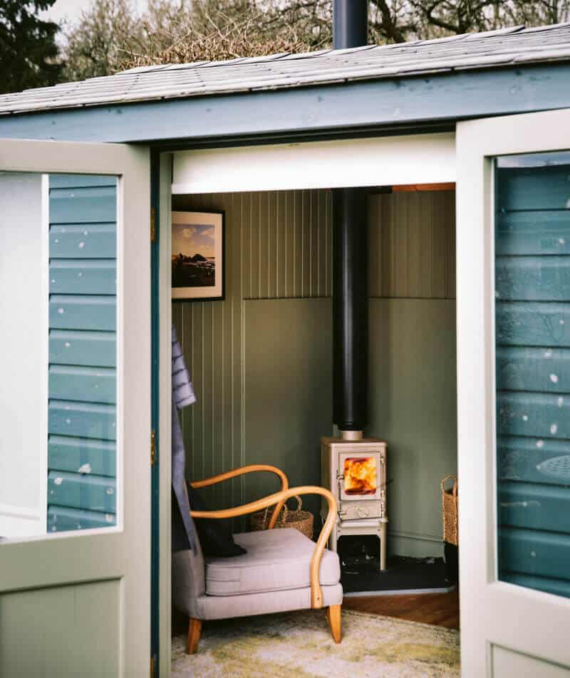 small log burner installed in a garden room office thumbnail