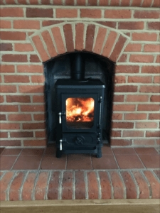 Small Stove Installed in a Household Fireplace