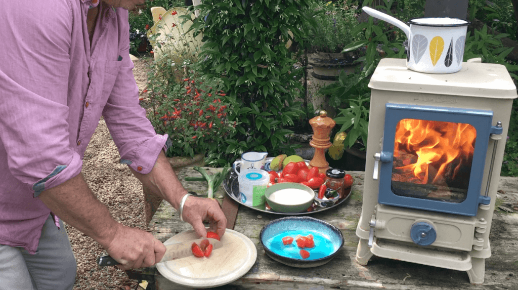 chopping-tomatoes-to-cook-on-a-small-wood-burning-stove
