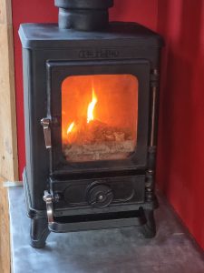 small wood burning stove in a converted removals lorry campervan