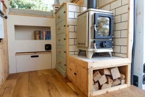 small wood burning stove in a renault master conversion