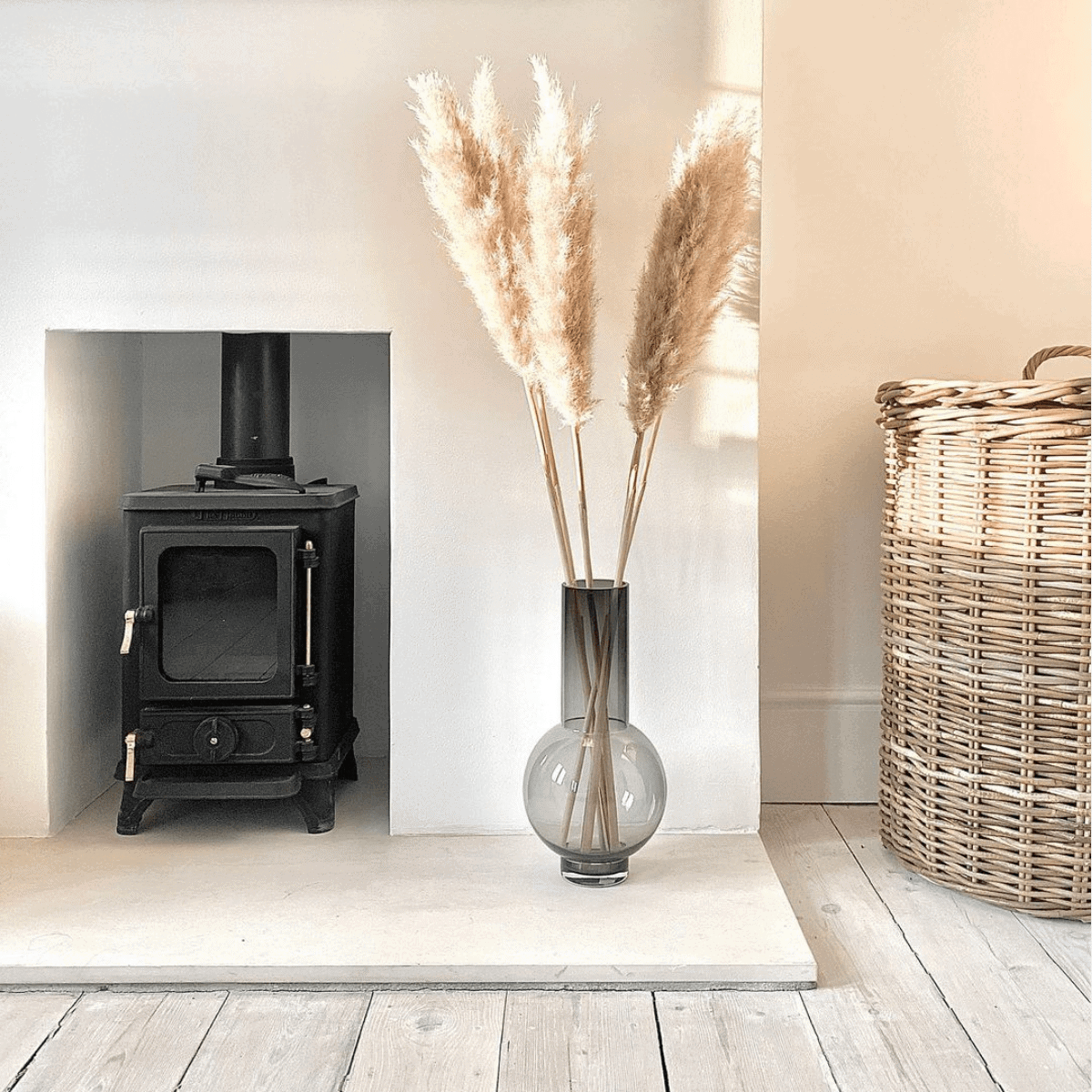 small wood burning stove installed in a small fireplace