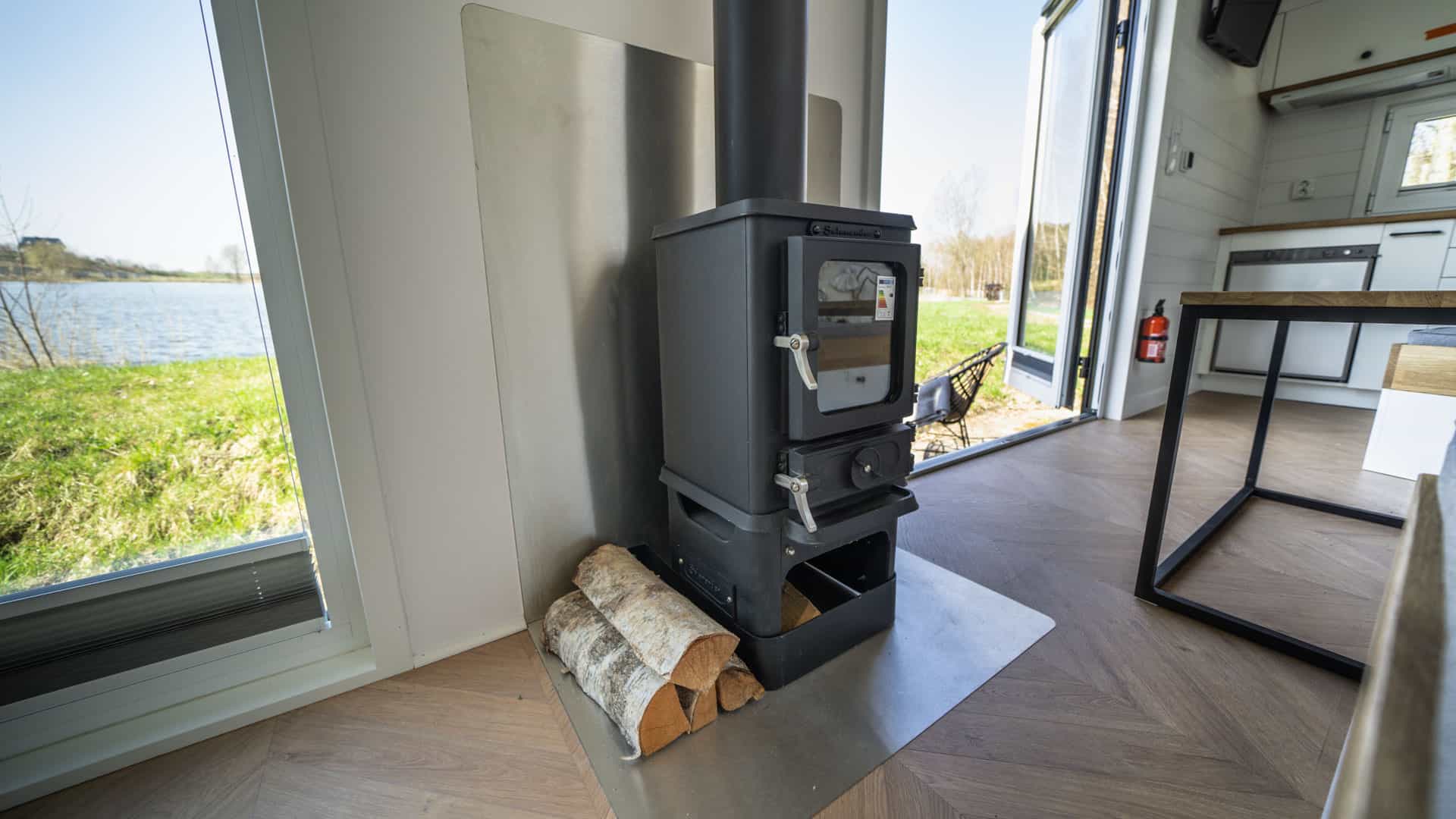 small wood burning stove installed in a tiny home mobi house