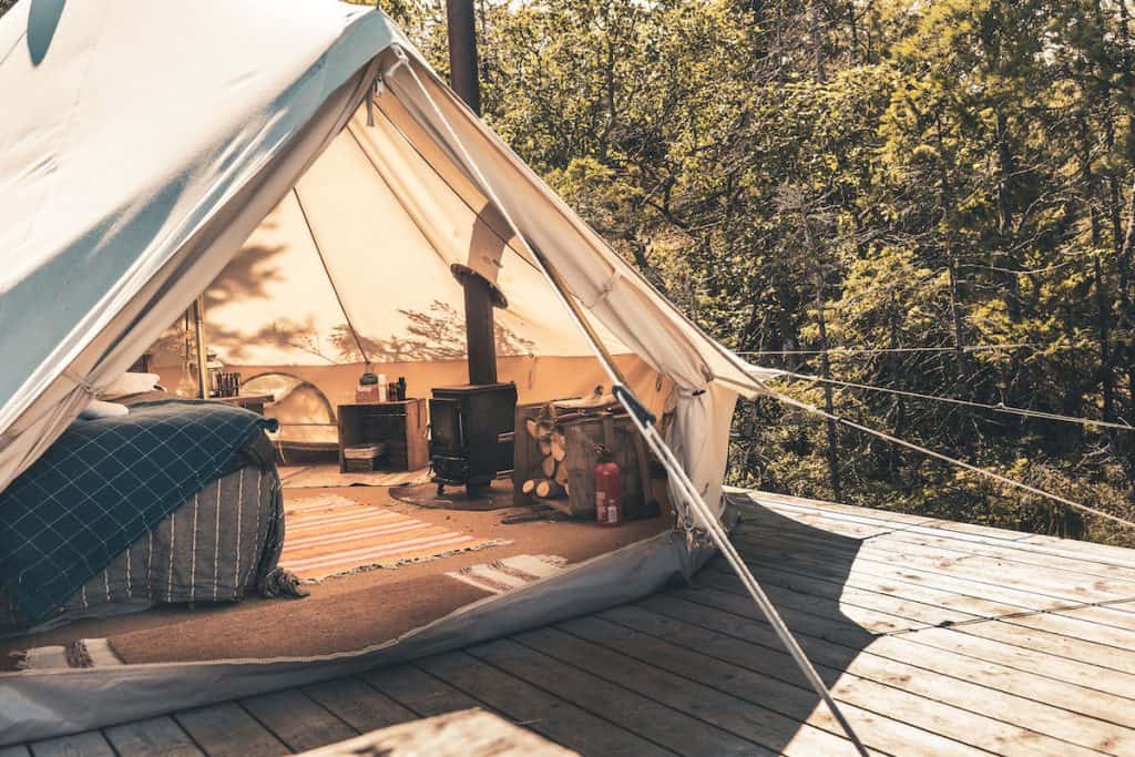 small wood stove installed in a glamping tent 3