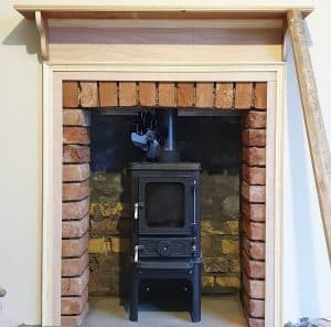 Hobbit small wood burning stove installed in a small household fireplace Beresford Project 4