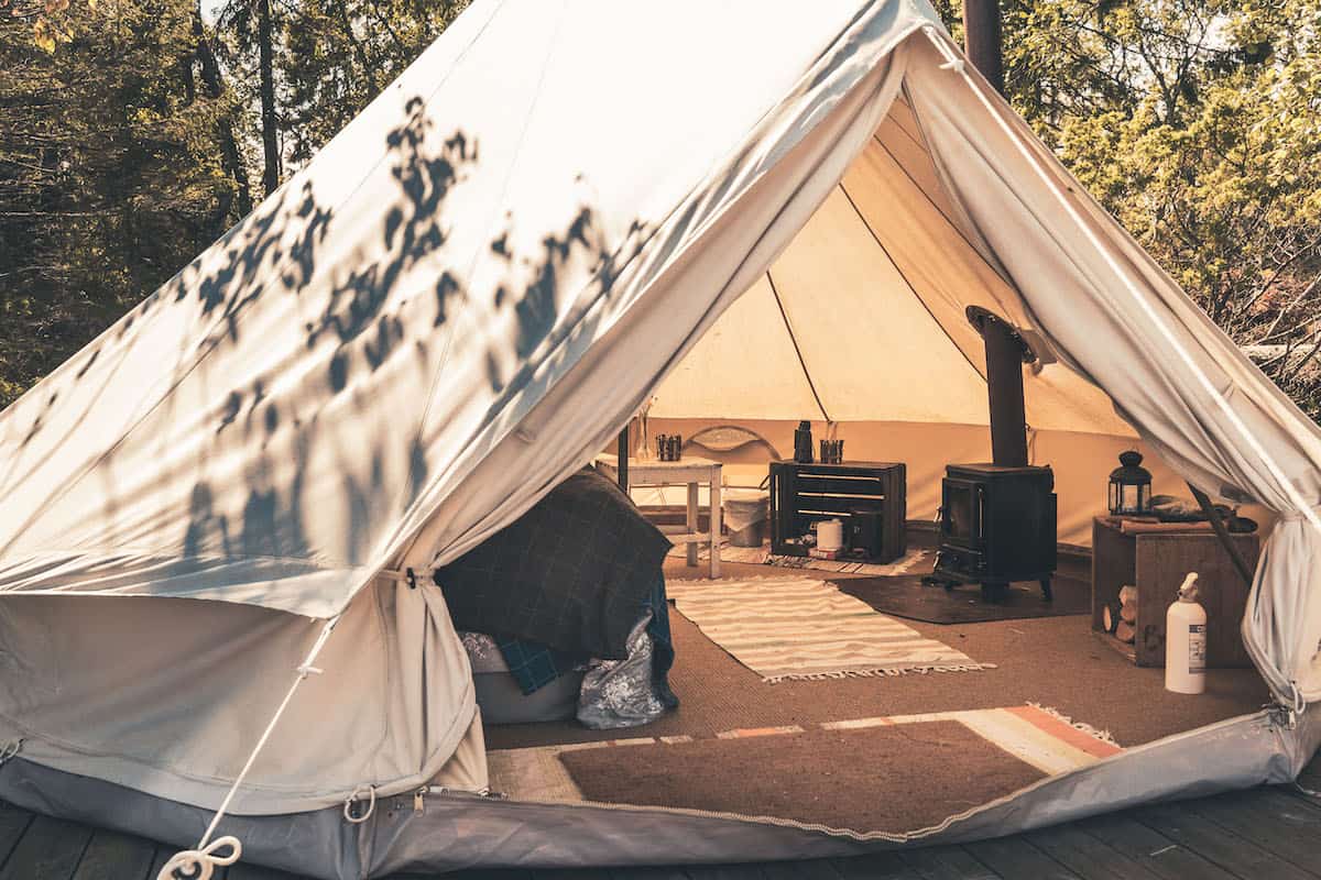 small wood stove installed in a glamping tent 8